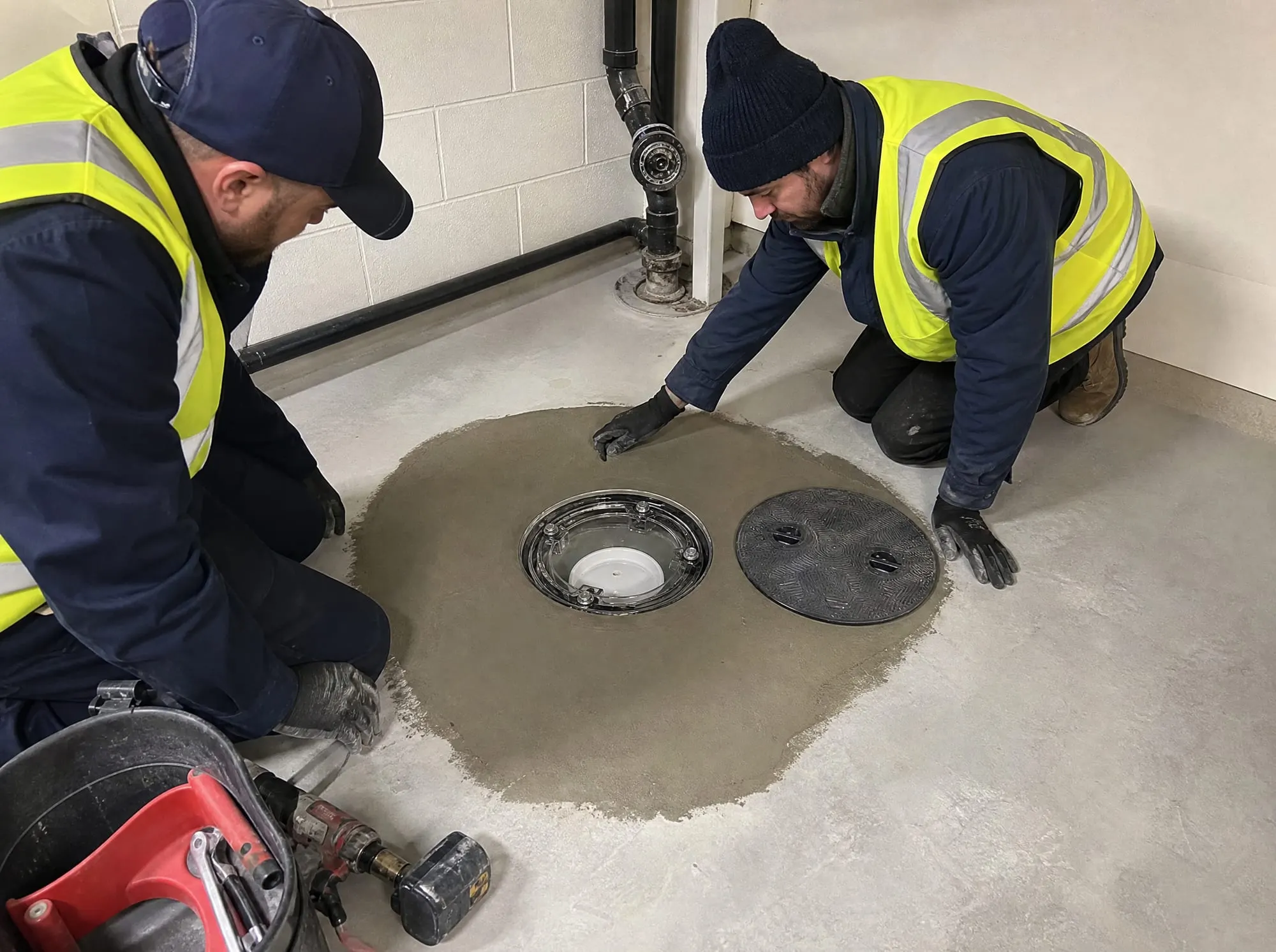 Illustrative photo of a clear-lid backwater valve installed in a basement floor